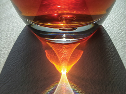 The curved surface of a glass of tea