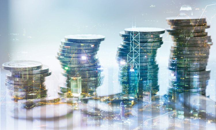 Stacked coins overlayed with a bar graph and cityscape