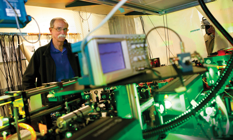 Researcher sitting in a lab writing