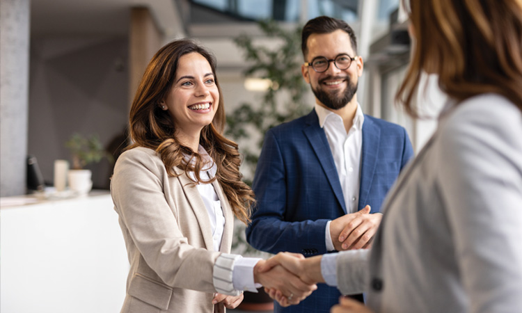 People smiling and shaking hands