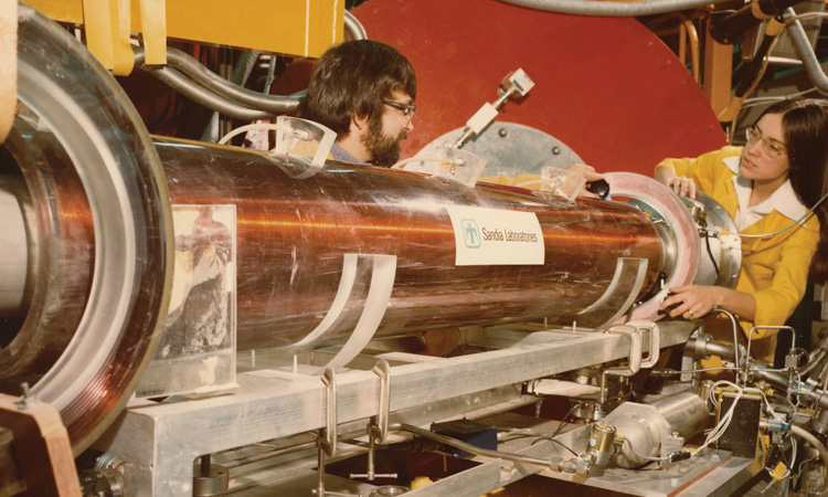 A. Kay Hays (right) and G.C. Tisone with the electron-beam generator at Sandia National Laboratories