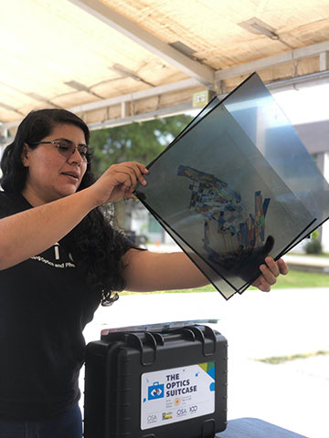 Ana Karen Reyes holding up optical teaching tools