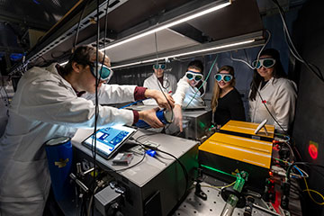 Researchers in lab with spectrometer