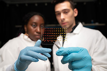 Researchers holding up printed material