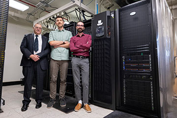 Three scientists standing together in a lab