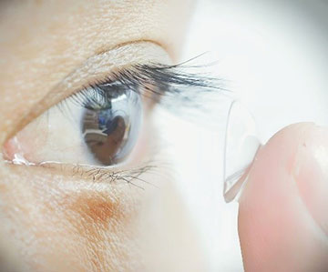 Contact being applied to a human's eye