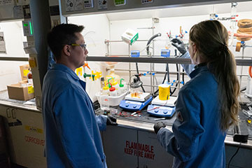 Male and female researchers in a laboratory setting