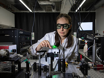 Woman in lab cutting bone with a laser
