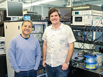 Two male researchers standing in lab