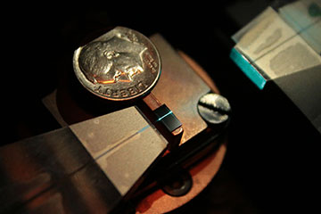 Tiny rectangular chip next to a dime