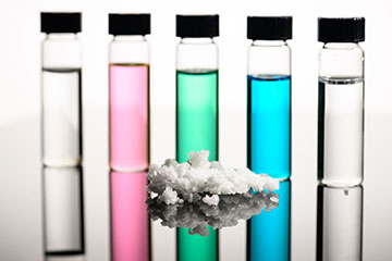 vials of colorful liquid in front of salt